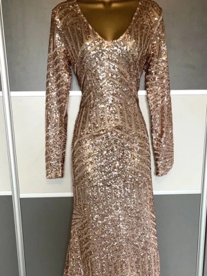 Glittrig maxi balklänning - Snygg festlig långklänning i mesh och champagnefärgade/roseguld paljetter. Helt oanvänd med prislapp från boohoo. Perfekt till fest/bal. Storlek 38