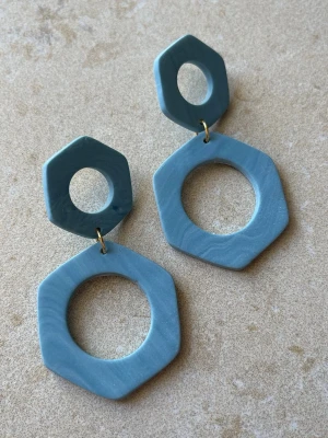 Handgjorda örhängen i blått - geometrisk design - Handgjorda örhängen i polymerlera  Geometrisk design i blå toner – enkla men med tydlig form.  Ca 6 cm långa – lagom storlek som syns utan att bli för stora.  Antiallergiska detaljer Lätta Flera par finns  Skriv om du vill se exakt par innan köp  Skickas