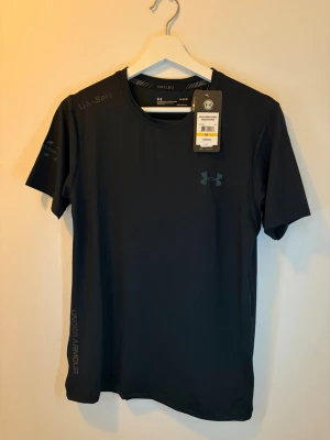 Svart set Under Armour - Säljer ett helt nytt svart set från Under Armour med t-shirt och shorts. Storlek M sitter perfekt. Perfekt till sommaren om du vill ha en clean outfit eller passar bra till ett träningspass.
