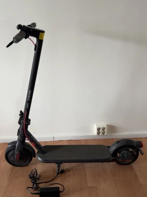 Xiaomi Electric Scooter 4 Lite med laddare  - Säljer en svart elscooter från Xiaomi som kommer med laddare. Ringklockans fäste är skadat och ser därför inte ny ut, men det påverkar inte elscooterns funktion. Scootern kör, bromsar, laddar och fungerar som den ska.