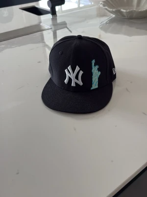 New Era Yankees keps - Snygg svart New Era keps med New York Yankees-logga | den är i mycket bra skick, 9/10 | köpt för 550kr | storlek 7, 56,8 cm | pris kan diskuteras!