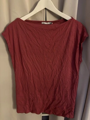 Topp med bred halsringning - En enkel topp med bred halsringning och korta ärmar, den är helt oanvänd med prislappen kvar.  från lager 157 storlek M. Ostruken just nu men kan strykas innan leverans om önskas