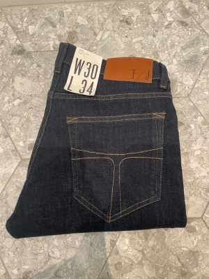 Tiger of Sweden jeans - Hej, säljer ett par mörkblå Tiger of Sweden jeans i oanvänt skick. Jeansen har kvar prislappen och har aldrig används. Storlek: W30, L34. Hör av dig om du vill ha fler bilder, eller bara har frågor att ställa(inga är för dumma)!🙌// Milo. 