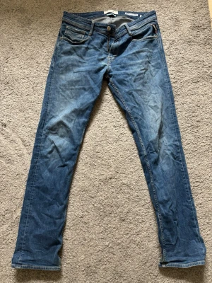 Blå jeans från Replay Rocco - Snygga blå jeans från Replay, modell Rocco med comfort fit. Klassisk femficksdesign och dragkedjegylf. Jeansen har en lätt tvättad look och är tillverkade i denim från deras Sustainable Lab.