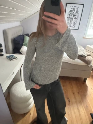 Grå långärmad tröja med utsvängda ärmar - Mysig grå långärmad tröja med utsvängda ärmar. Tröjan har en jätte skön och perfekt att ha till vardags. Storlek S men skulle säga att den passar M