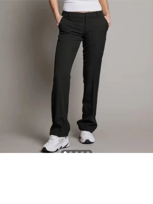 Svarta raka kostymbyxor - Snygga svarta kostymbyxor med rak passform och pressveck. Från bikbok, regular längd. Innerbenets längd är 81-82 cm. Dem är mid waist. 