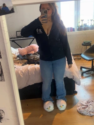 14+ dixie ultra low jeans - Säljer ett par ljusblå bootcut jeans med snyggt broderi på bakfickan. Jeansen har klassisk femficksdesign och är tillverkade i denim med lite stretch för skön passform. Perfekta för dig som gillar en avslappnad och trendig look. Jeansen är ifrån Gina och bara använd runt 2 gånger, säljer för att jag tycker dem är för stora, storlek 14+ L
