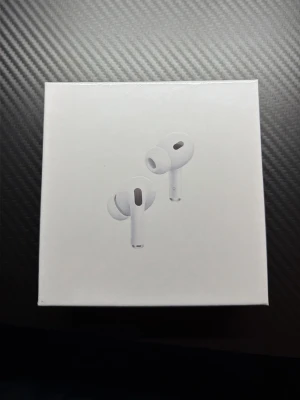 Apple AirPods Pro 2 USB-C - Apple AirPods Pro (2:a generationen) med MagSafe-laddningsetui och USB-C. Trådlösa in-ear hörlurar i vit färg med stilren och kompakt design. Perfekta för musik, samtal och brusreducering. Levereras i originalförpackning.