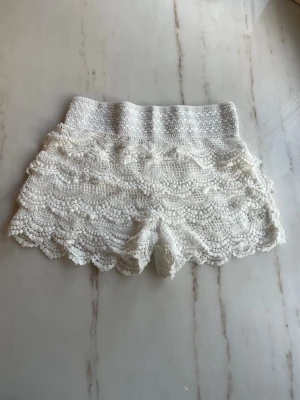 Vita spets shorts  - Vita spets shorts som är stretchiga i midjan och passar xs-m