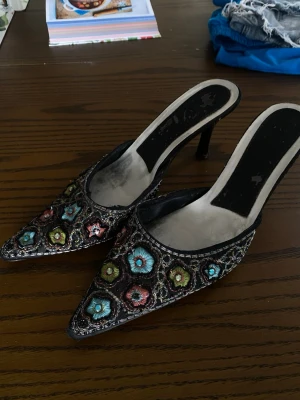 snygga broderade vintage pumps🙌 - Såå sjuuuukt vackra svarta pumps med spetsig tå och smal klack. Skorna är dekorerade med färgglada broderade blommor i blått, grönt och rosa💐🌺Köpta på plick men förra ägaren sa att de köptes i Nice! Slitaget på innersulan är inget som märks när du bär dom! Storlek 40 men passar 39💞💞