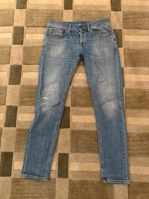 Dondup george skinny fit - Nyaste modellen av dondup george i riktigt bra skick.Små slitningar som design på framsidan, fräscha jeans att ha fram till sommaren. Kontakta vid frågor eller funderingar!