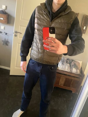 Grön väst - Snygg grön dunväst med quiltad design och dragkedja framtill. Västen har en hög krage och är lätt vadderad för extra värme. Perfekt att slänga över en hoodie för en avslappnad look. Märke: Luxan storlek: M. aldrig använd ute bara testad! Nypris:499kr. Säljs pågrund av att jag beställde fel färg. Personen på bilden är 180cm och väger 70kg