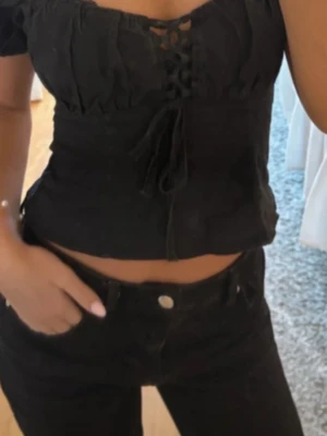 Svart offshoulder topp med snörning - Super söt fest topp som tyvärr ej passa! Super fin i skicket. Det står att den är storlek 36 men skulle säga att den sitter som en XS!💕