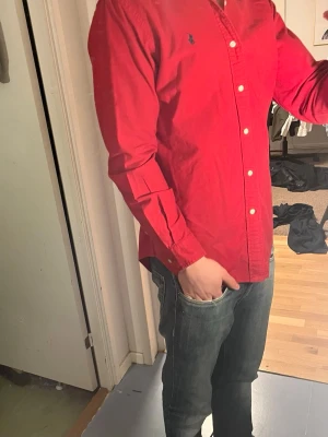 Ralph Lauren Skjorta - Tja säljer nu en Ralph Lauren skjorta i storlek S o färgen Röd. Fint skick på skjortan utan några tydliga defekter. Nypris runt 1295 mitt pris 199kr. Hör av dig vid frågor eller funderingar.
