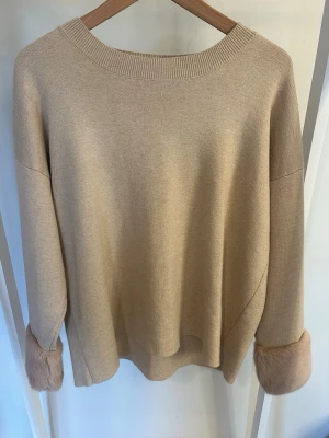 Beige stickad tröja  - Säljer en beige stickad tröja från Holly & Whyte (Lindex), använd fåtal gånger. Tröjan är mjuk och ganska tjock i ärmarna. Perfekt för dig som gillar neutrala färger och trendiga detaljer.
