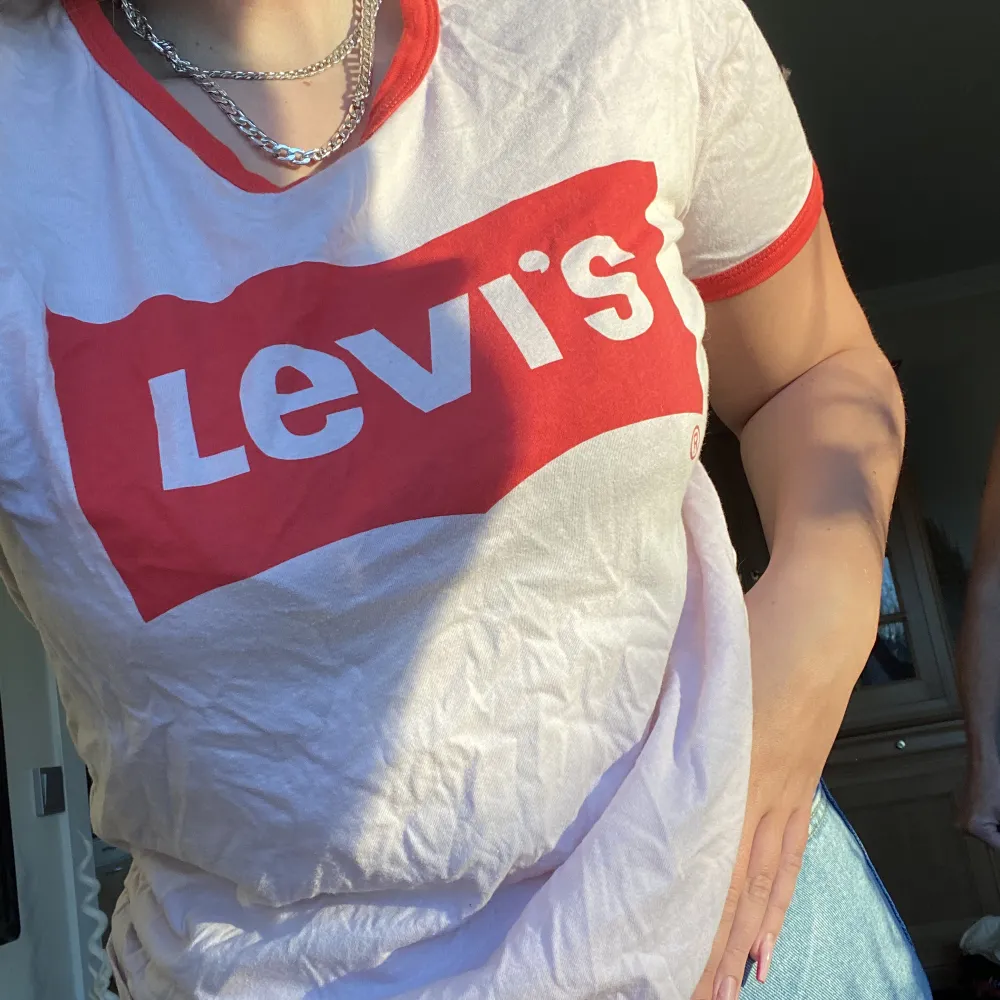 Ljusrosa Levis T-shirt med röda tetaljer  (Använd få gånger) . T-shirts.