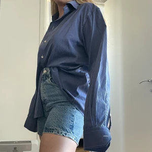 Eton skjorta  - Blårandig skjorta från Eton. Det är en herrskjorta i storlek 42. Passar de flesta storlekar antingen som oversized skjorta eller skjortklänning