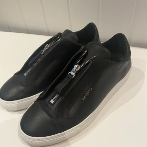 Arigato Skor  - Oanvända Axel Arigato sneakers i svart skinn. Strl 38, aldrig använda på grund av för liten storlek. 