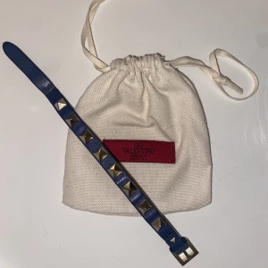 Valentino armband - Mörkblått valentino armband i använt med fortfarande fint skick. Som ses på bild 2 är det lite defekt, går dock att fixa med lim om man vill! Låda, dustbag och extra nit ingår❤️kan gå ner i pris vid snabb affär. 