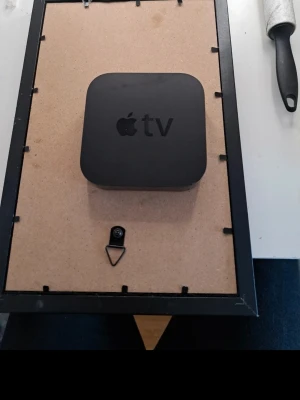 Apple TV med fjärrkontroll - Säljer en svart Apple TV mediaspelare tillsammans med en silverfärgad fjärrkontroll i aluminium. Perfekt för att streama filmer, serier och musik direkt till din TV. Smidig och stilren design som passar in i alla hem.
