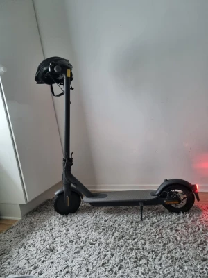 Xiaomi Elscooter - Elektrisk scooter i svart med grå detaljer och digital display på styret. Scootern har stora hjul, reflexer och medföljer en svart cykelhjälm. Perfekt för smidig transport i stan. Åker 20kmh och hämtas endast i Vimmerby ej frakt!