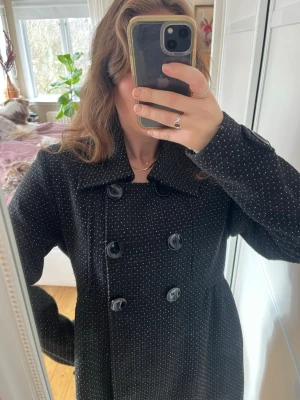 Svart prickig dubbelknäppt kappa coat - Prickig kappa med knappar. 