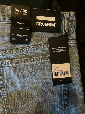 Dr Denim Dash ljusa raka jeans - Ljusblå jeans från Dr Denim, modell Dash, med relaxed/straight fit och mid rise. Klassisk femficksdesign och retrovibbar. Perfekta för en avslappnad streetwear-look. Materialet är denim i bomull. Snygga till sneakers eller boots.