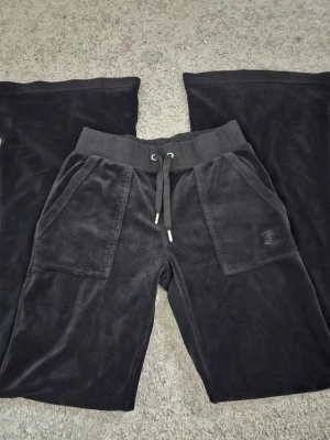 juicy couture byxor -  Vid fickorna är tråden lite av man kan se på första bilden men inget jag tänker på de är som ett litet hål där tråden är av men de går nog jättebra att sy ihop man kan se att de är använda men endå fina. PRIS KAN DISKUTERAS jag vet dock inte vad de är för model men jag tror de är lågmidjade 😊 de är mörkare i verkligheten 