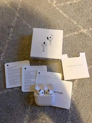Apple AirPods med laddningsetui active noise cancellation - Säljer ett par vita Apple AirPods med trådlöst laddningsetui. Hörlurarna har en stilren och kompakt design i blank plast och levereras med originalförpackning och manualer. Perfekta för musik, samtal och träning tack vare smidig Bluetooth-anslutning. Dem är active noise cancellation. Garantin finns även kvar som räcker till 2026-07-14. Dem är nya och är använda typ 2 gånger 