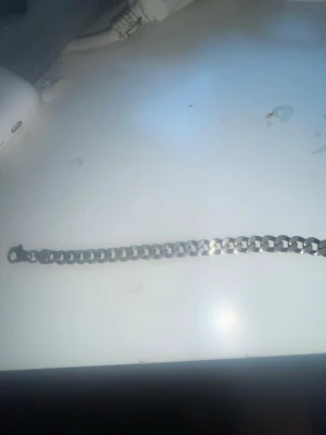 Kedjearmband i silverfärg - Snyggt armband i silverfärgad metall med breda, platta länkar och karbinlås. Perfekt accessoar för dig som gillar en stilren och modern look. Passar både till streetwear och mer klassiska outfits.