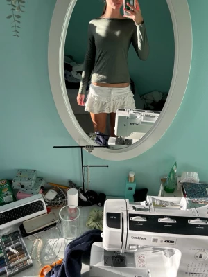 Mörkgrön långärmad topp - En enkel och stilren mörkgrön långärmad topp med rund halsringning. Toppen har en slim passform och är tillverkad i ett mjukt material som känns skönt mot huden. Perfekt att matcha med jeans eller kjol för en clean look.