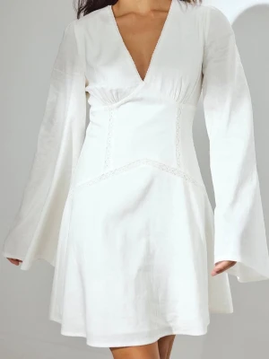 Vit klänning med v-ringning - Säljer en superfin vit kortklänning med v-ringad hals och långa, vida ärmar. Klänningen har broderade detaljer  och markerad midja som ger en snygg siluett. Aldrig använd och passar perfekt för skolavslutning eller student! (Helt slutsåld!!!) 