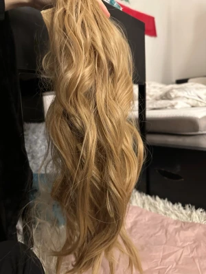 Blonda lockiga löshår clips - Säljer ett set med blonda löshår clips med långa, mjuka lockar. Clipsen är enkla att fästa och ger ett naturligt svall. Perfekt för dig som vill ha extra volym och längd på håret. Materialet känns mjukt och följsamt.