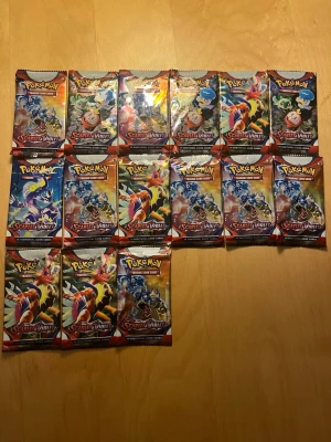 Pokémon Scarlet & Violet boosterpaket - Säljer flera oöppnade boosterpaket från Pokémon Scarlet & Violet-serien. Varje paket innehåller 10 samlarkort och har färgglada omslag med olika Pokémonmotiv. Perfekt för dig som vill bygga din samling eller jaga nostalgiska kort! OBS (ej äkta).