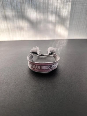 Christian Dior armband - Helt nytt Christian Dior armband i färgen grå. Inga skador eller missfärgningar. Har ett till likadant vilket går att köpa också. Skriv vid frågor eller funderingar. Pris går att förhandla. Skickar snabbt 📦🚚💨