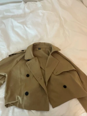 Trenchcoat  - Säljer denna trenchcoat. Den är i nytt skick. För mer frågor eller bilder skriv privat. Jackan är inte ifrån berhska men behövde ta det för märket inte fanns med