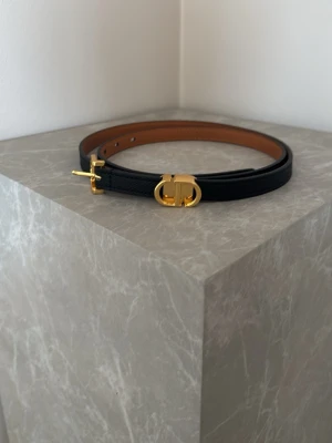 Svart smalt bälte med gulddetaljer - Snyggt svart bälte till första hålet är det 94 cm 