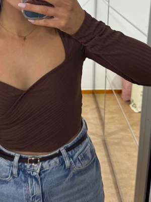 Brun topp  - En brun topp från NAKD i stl S som är använd endast en gång säljs för 150 kr. 