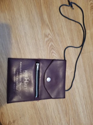 Vintage leather photo envelope/bag  - Burgundy leather outside, soft inside. 1 zipper pocket, 1 larger clasp pocket. Several signs of wear, but it still works as intended.   Bundle discounts: two items 5% off (automatic) three items 10% off, five items 20% off. Message me before purchasing 3+ items for discount.