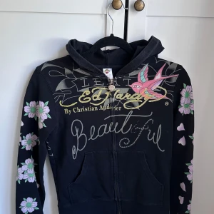Svart vintage Ed Hardy hoodie 🖤 - Snygg svart hoodie från Ed Hardy med mycket tryck och detaljer, jag har typ aldrig använt den och den är i bra skick för att vara vintage. 