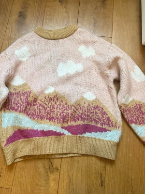 Rosa och beige tjocktröja med berg - Rosa och beige tjocktröja med berg i barnstorlek 164