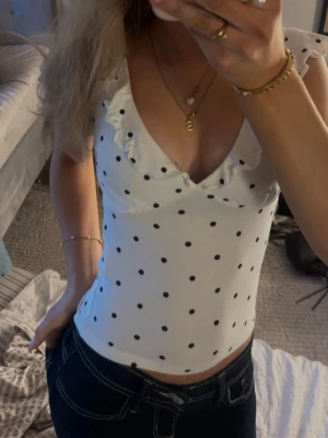 Vit prickig topp med volang - Supersöt vit topp med svarta prickar, använd en gång. Slut på hemsidan💕🍸💐