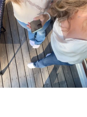 Vit siden-linnetopp med tunna band - Jätte fin siden topp med klitter band ifrån hm, använd endast en gång men den är skrynklig då den har legat i min byrå sen dess