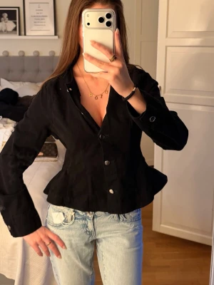 Svart jacka med markerad midja.  - Så snygg jacka från Gina som också är snygg bara som en topp, man kan ha den på två olka sätt. Passar mig som är en xs/s