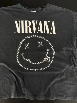 Washed black Nirvana t-shirt - Washed black Nirvana t-shirt   Size: XS (fits oversized) Condition: used, in good condition  Details: graphic print on front and back  💰 Price: 60 kr  📦 Fast shipping / meet-up possible Message me if interested 💌