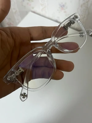 Klara solglasögon  - Snygga solglasögon från Chrome Hearts med transparent båge och silverfärgade detaljer. Glasögonen har en klassisk rektangulär form och är tillverkade i syntetmaterial. Perfekt accessoar för dig som vill sticka ut med stilrena detaljer.