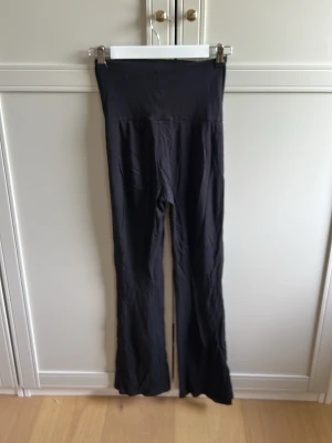 Svarta leggings  - Säljer ett par svarta leggings med utsvängda ben. De har en stretchig passform som sitter snyggt på kroppen. Perfekta till både oversized tröjor och crop tops. Materialet känns mjukt och följsamt. storlek 146/152 (inte 30)❤️