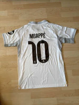 #10 Kylian Mbappe Real Madrid Hemma Kit 2025/26 - Stilren fotbollströja i helt nytt skick. Tröjan är inte använd en endaste sekund.