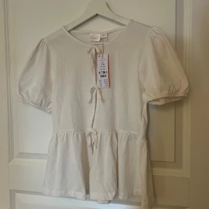 Vit blus med puffärm och knyt - Söt vit blus med puffärm ifrån gina tricot Stolek 170❤️ aldrig använd prislapp kcar