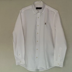 Polo Ralph Lauren Skjorta - Tjena! Säljer en stilren vit skjorta från Ralph Lauren. 🙌 Superbra skick, knappt använd. Perfekt nu till våren. 🌞 Säljer för endast 699kr (Köpt för 1295kr från Zalando). Kvittot finns. Hör av er vid funderingar eller om ni vill se mera bilder :)